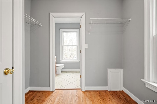 walk in closet with hardwood / wood-style flooring