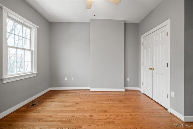 unfurnished bedroom featuring light wood-type flooring and ceiling fan