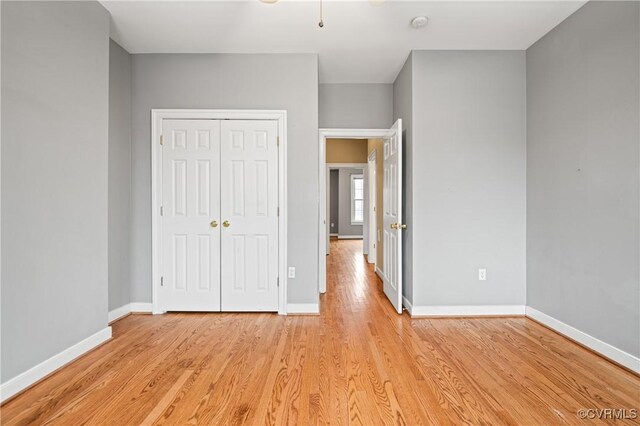 unfurnished bedroom featuring a closet and light wood-type flooring