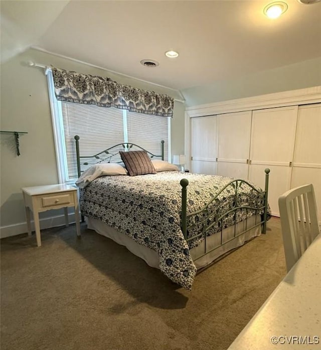 bedroom featuring carpet, visible vents, and vaulted ceiling