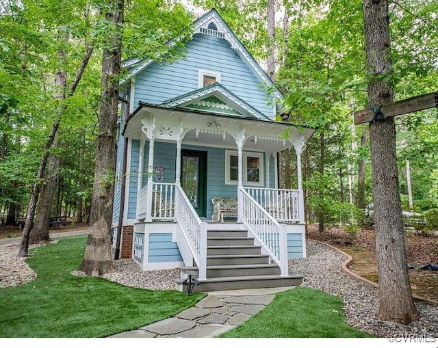 victorian home featuring a porch and a front lawn