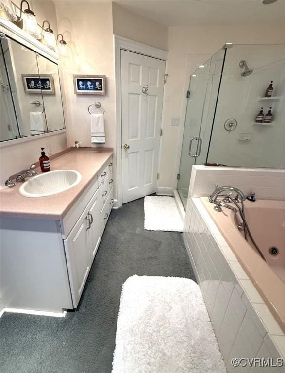 full bathroom with baseboards, a shower stall, a whirlpool tub, and vanity