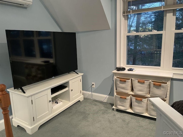 interior space with carpet floors, baseboards, and a wall mounted air conditioner