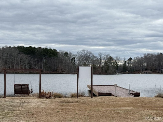 dock area with a water view and a wooded view