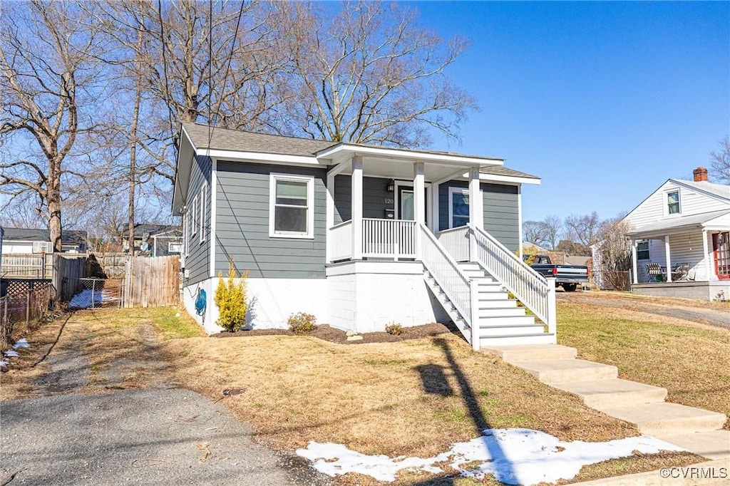 bungalow-style home with a porch and a front lawn