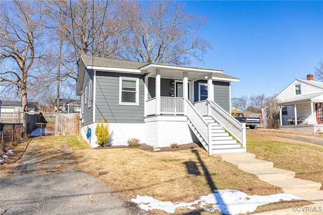 bungalow-style home with a porch and a front lawn