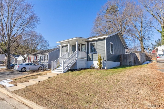 view of front of home featuring covered porch and a front lawn