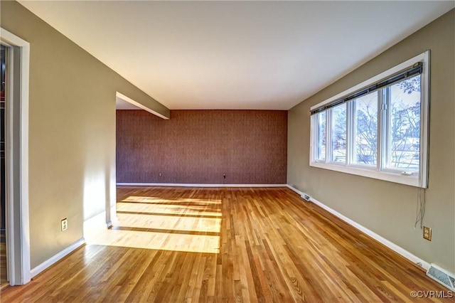 spare room featuring hardwood / wood-style flooring