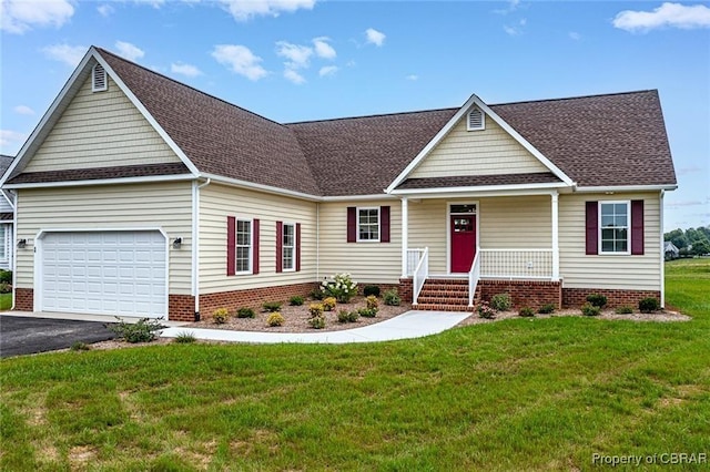 view of front of property featuring a porch, a front lawn, and a garage