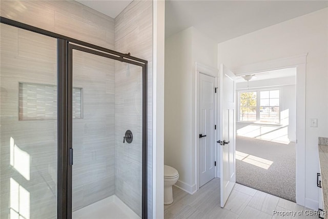 bathroom featuring toilet and walk in shower