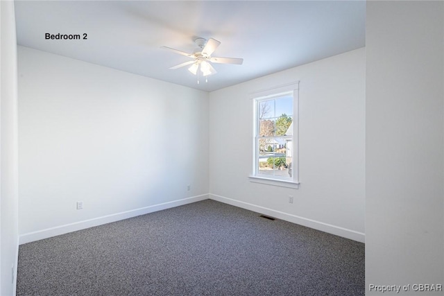 carpeted empty room with ceiling fan