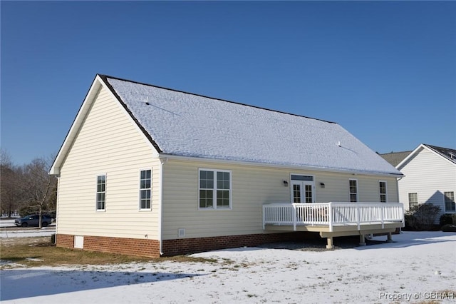 snow covered property with a wooden deck