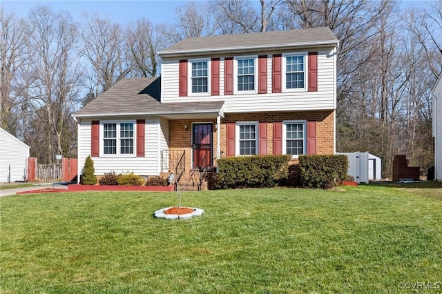 view of front of house with a front yard and a shed