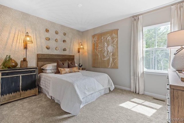 bedroom featuring light carpet