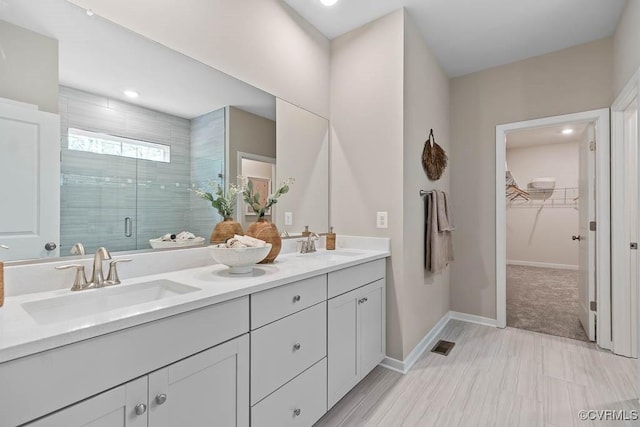 bathroom with an enclosed shower and vanity