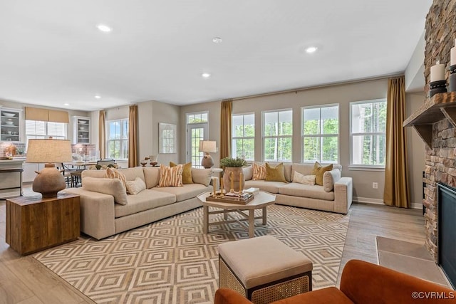 living room with a fireplace and light hardwood / wood-style floors