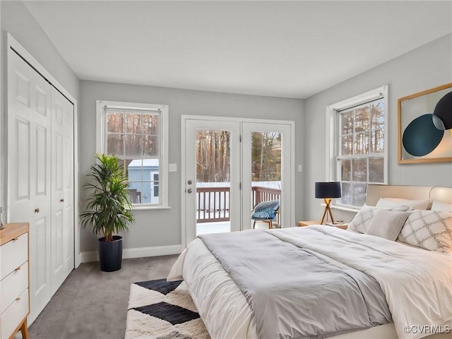 bedroom featuring access to outside, light colored carpet, and a closet