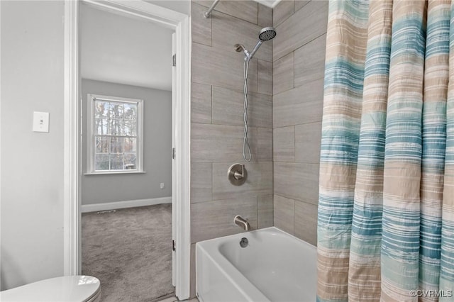 bathroom featuring toilet and shower / bathtub combination with curtain