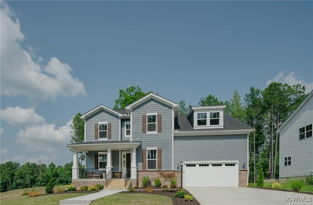 view of front of home with a porch, a front lawn, and a garage