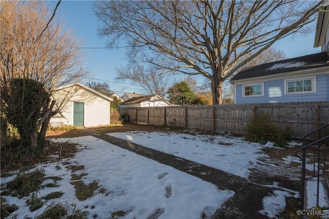 yard covered in snow featuring an outbuilding