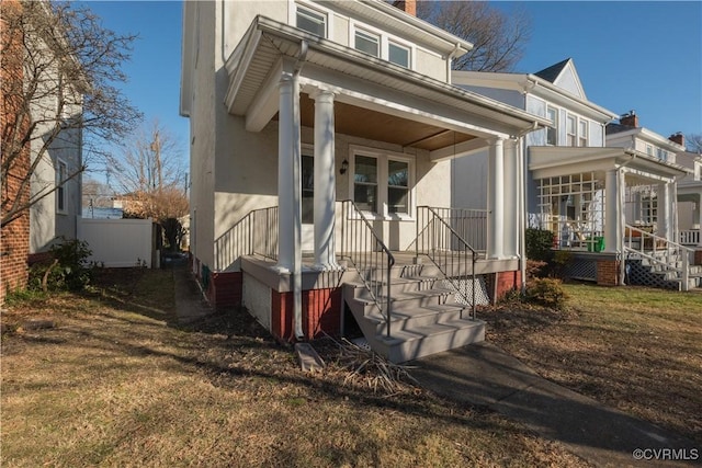 view of front of house with a porch and a front yard