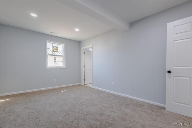 spare room with beamed ceiling, visible vents, recessed lighting, carpet floors, and baseboards