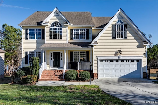 view of front of house featuring a garage, a porch, and a front lawn