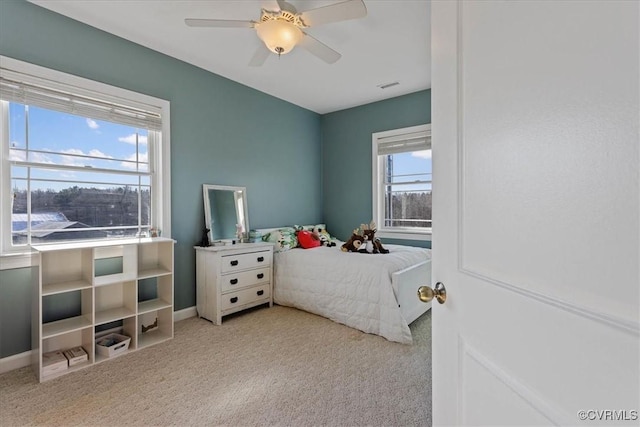 bedroom with ceiling fan and light carpet