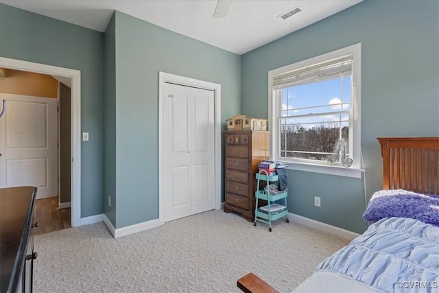 carpeted bedroom featuring a closet and ceiling fan