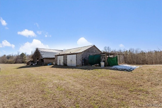 view of property exterior with a yard and an outdoor structure