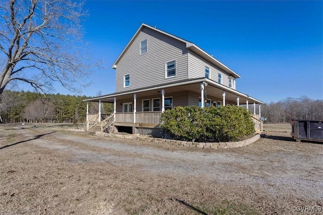 back of property featuring covered porch