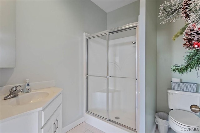 bathroom featuring an enclosed shower, vanity, tile patterned floors, and toilet