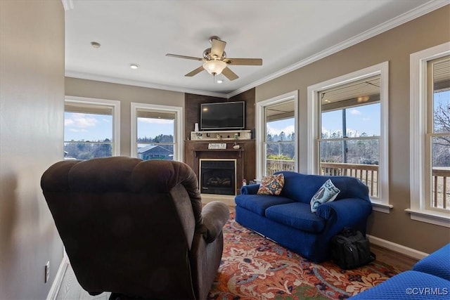 living room featuring crown molding, wood-type flooring, and ceiling fan