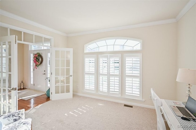 interior space with crown molding and french doors