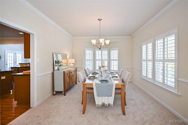 dining space with a chandelier, light colored carpet, and ornamental molding