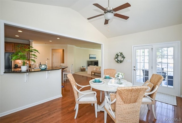 dining space featuring ceiling fan, vaulted ceiling, and hardwood / wood-style floors