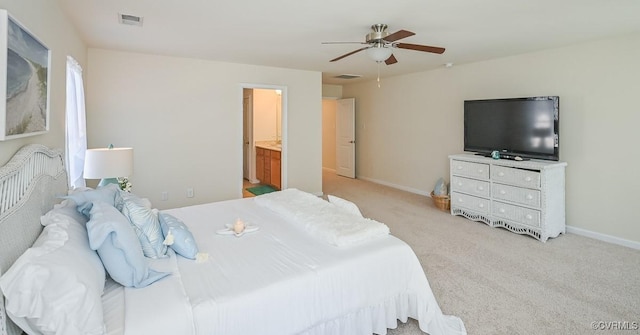 carpeted bedroom with ceiling fan and connected bathroom