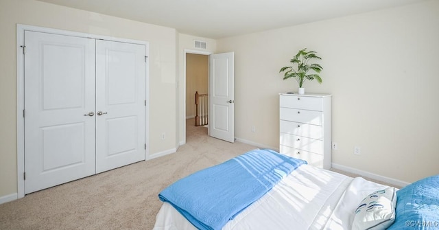 bedroom with light carpet and a closet