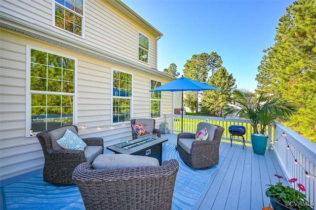 wooden deck with a fire pit