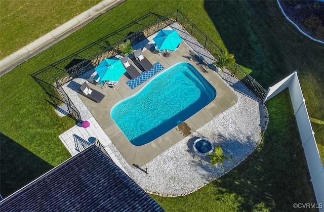 view of pool featuring a patio area and a lawn