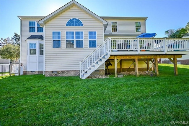 rear view of house with a yard and a wooden deck