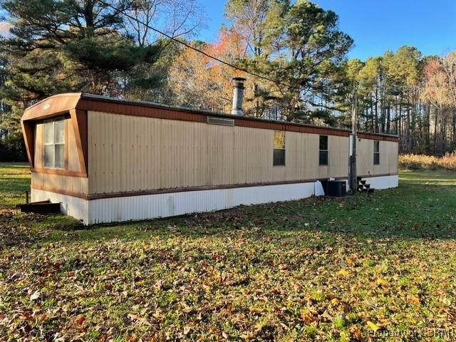 view of side of home with a yard