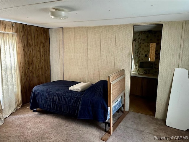 bedroom with wooden walls and carpet