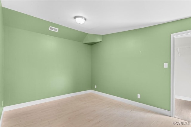 empty room with light hardwood / wood-style flooring