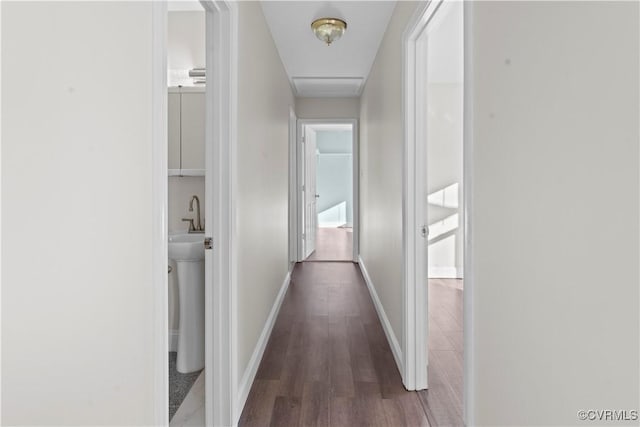 hallway with dark hardwood / wood-style flooring