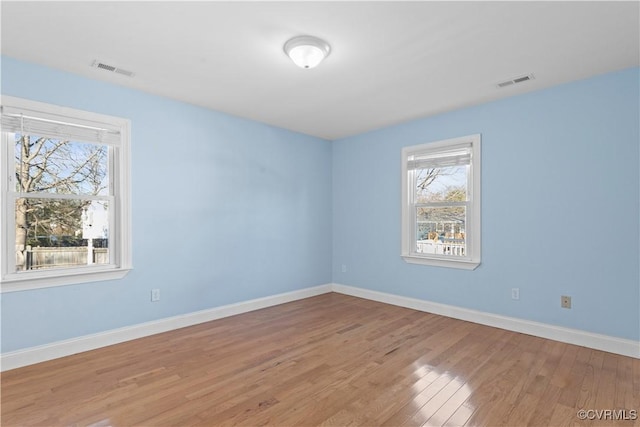 empty room with light hardwood / wood-style flooring