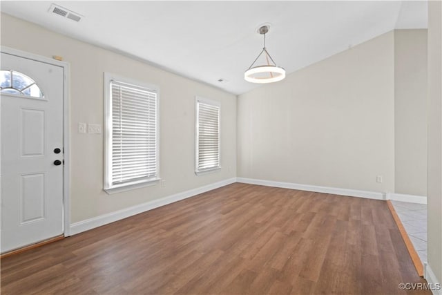 entryway with wood-type flooring and a healthy amount of sunlight