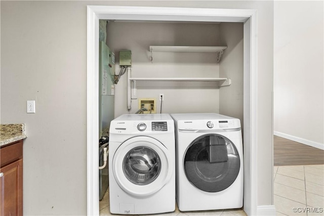 washroom with light tile patterned flooring and independent washer and dryer