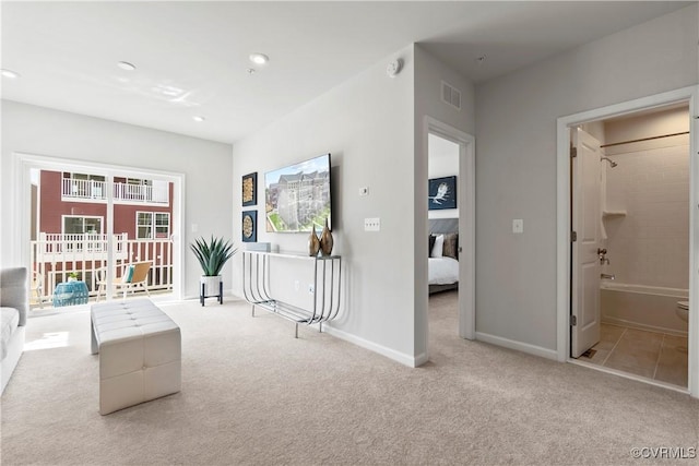 sitting room featuring light colored carpet