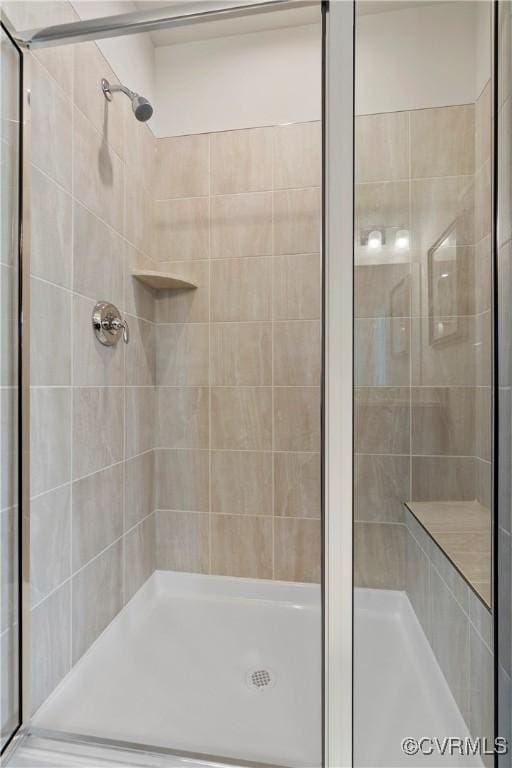 bathroom with a shower with door